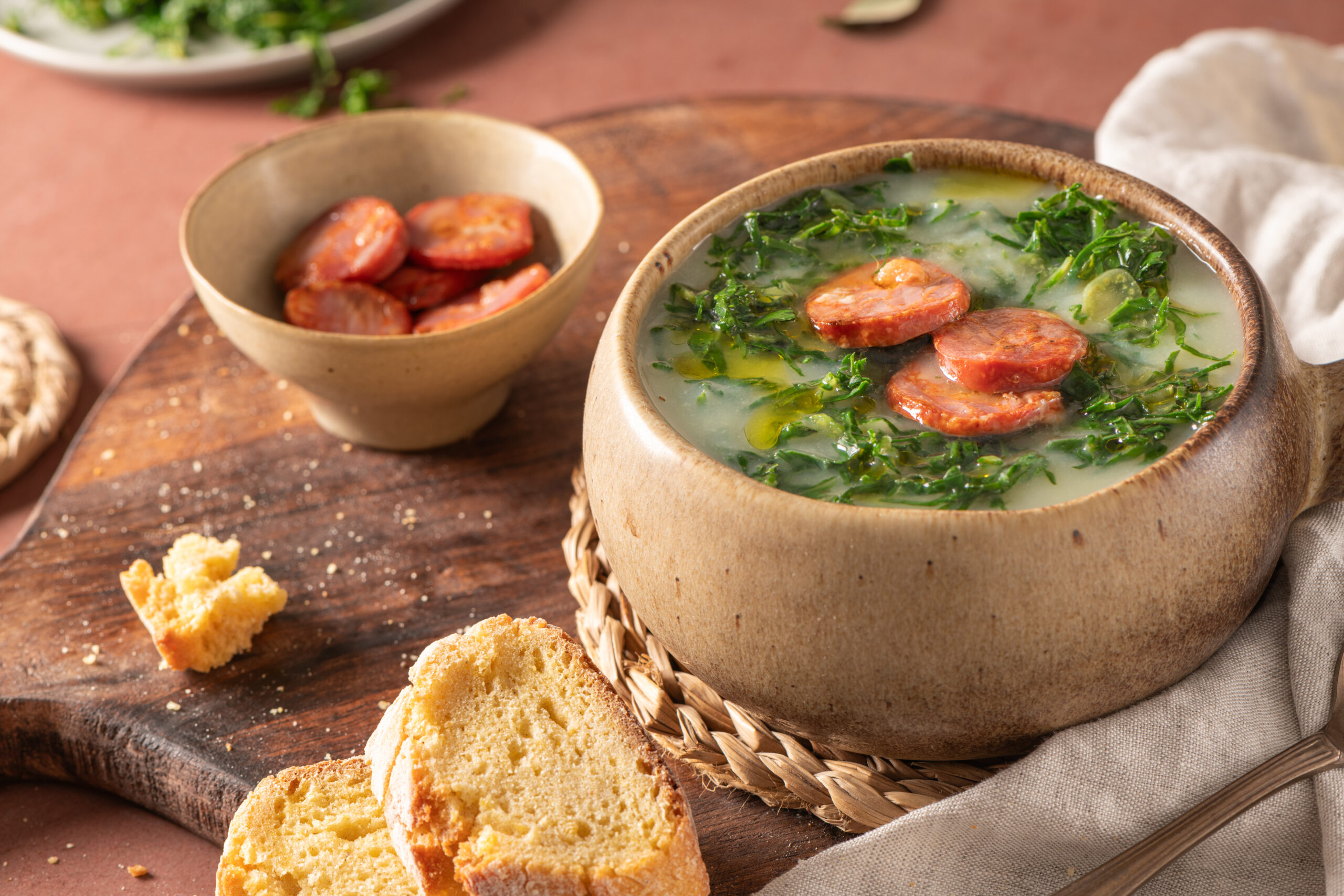 Caldo verde popular soup in Portuguese cuisine. Traditional ingredients for caldo verde are potatoes, onion, garlic, collard greens, chorizo , olive oil and salt. Is a comfort soup and is typically served with cornbread